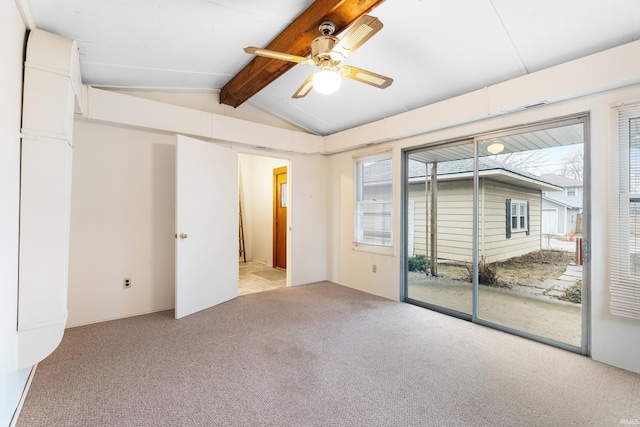 carpeted empty room featuring vaulted ceiling with beams and ceiling fan