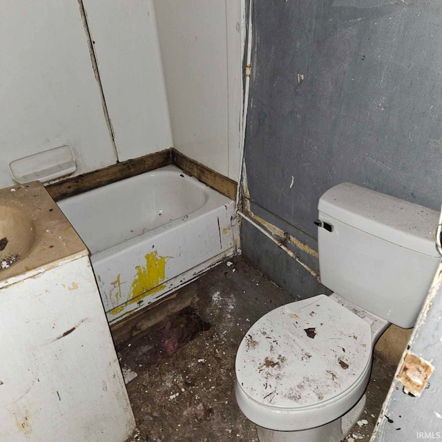 bathroom featuring vanity, a tub, and toilet