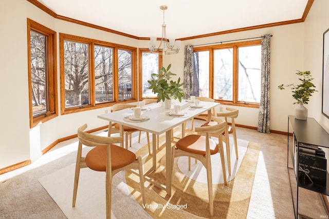 carpeted dining space with ornamental molding and a chandelier