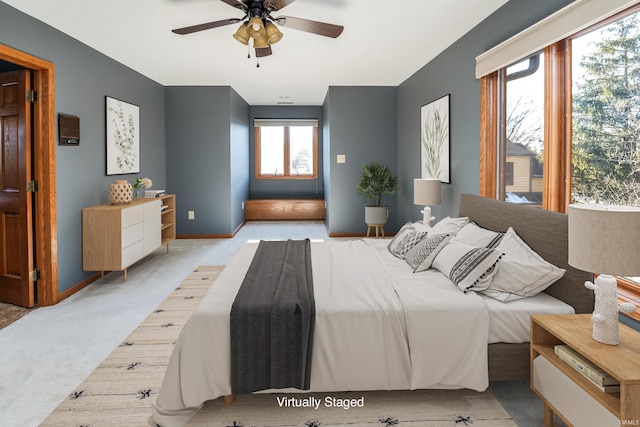 bedroom with ceiling fan and light carpet