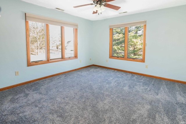 carpeted empty room featuring ceiling fan