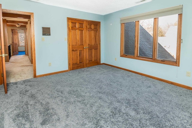 unfurnished bedroom featuring light colored carpet and a closet