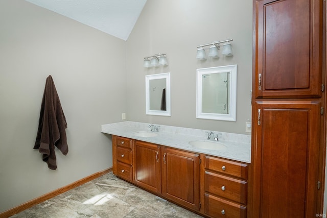 bathroom with lofted ceiling and vanity