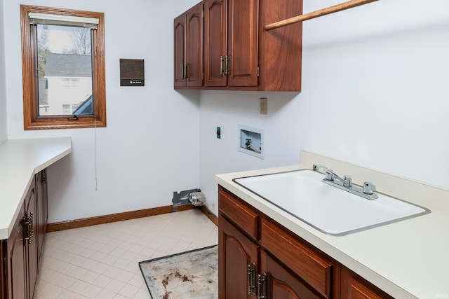 clothes washing area with sink, cabinets, light tile patterned floors, washer hookup, and hookup for an electric dryer