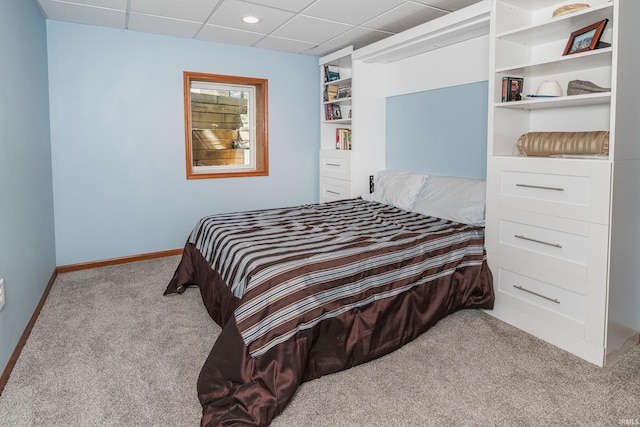 carpeted bedroom with a drop ceiling