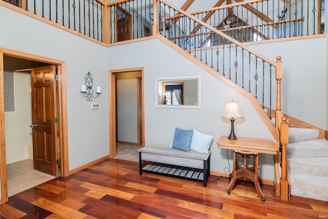 living room featuring hardwood / wood-style flooring and a high ceiling