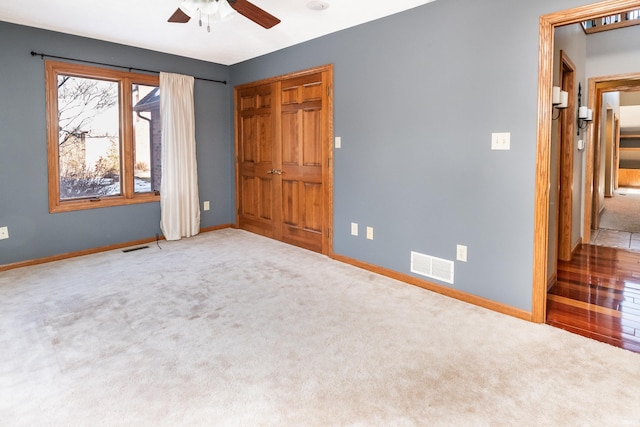 unfurnished bedroom with ceiling fan and carpet