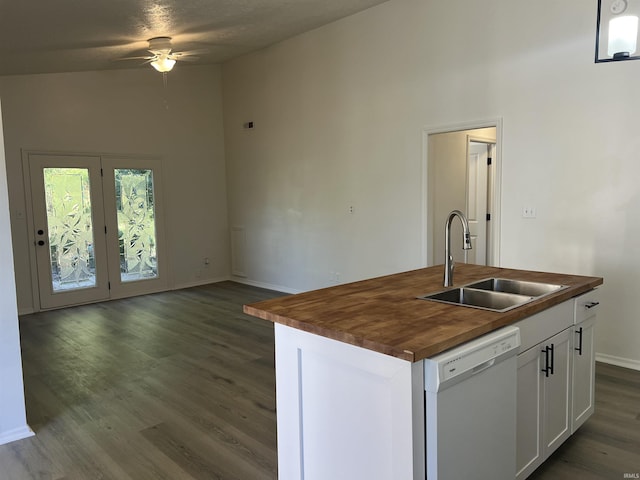 kitchen featuring wooden counters, sink, a kitchen island with sink, and white dishwasher