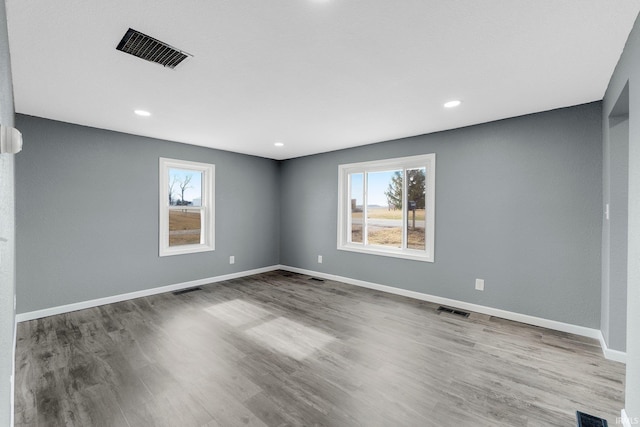 unfurnished room featuring hardwood / wood-style flooring