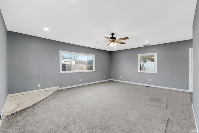 carpeted empty room featuring ceiling fan