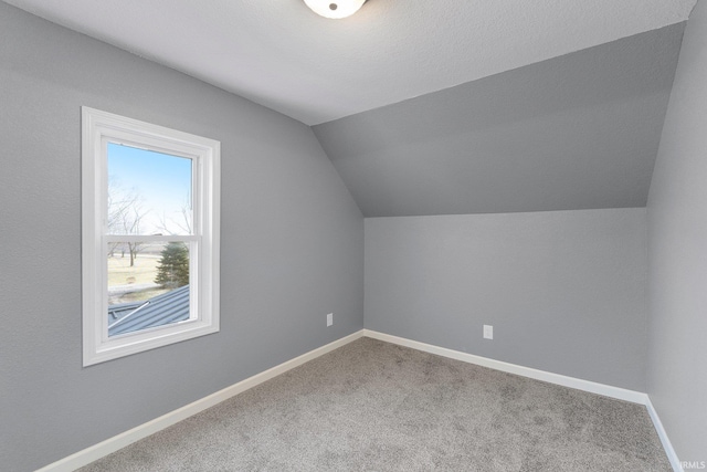 additional living space with lofted ceiling and carpet floors