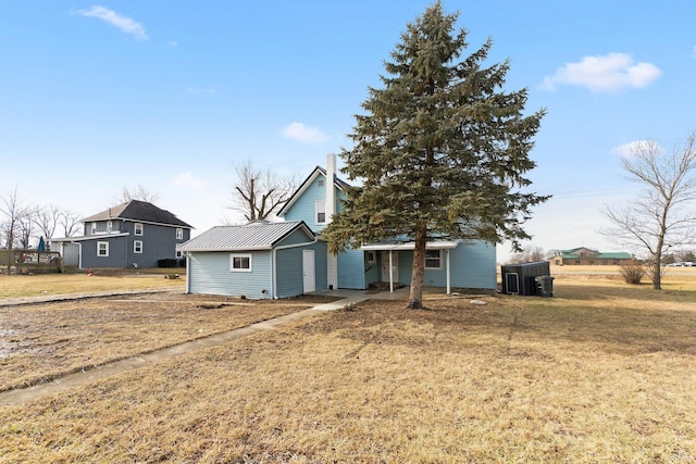 view of front of home featuring a front lawn and central air condition unit