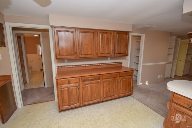 kitchen featuring light colored carpet