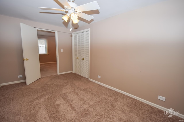 unfurnished bedroom with ceiling fan, a closet, and carpet