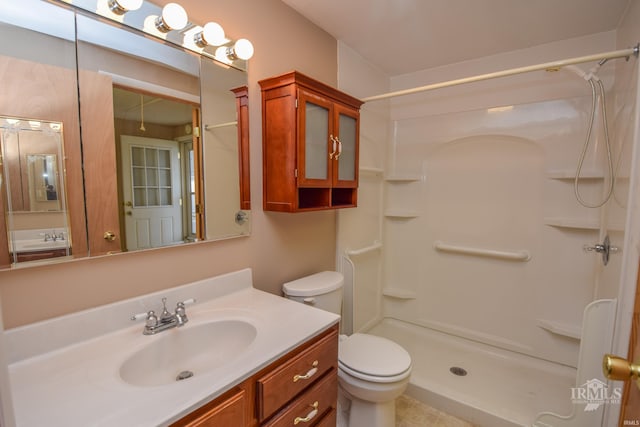 bathroom featuring walk in shower, vanity, and toilet