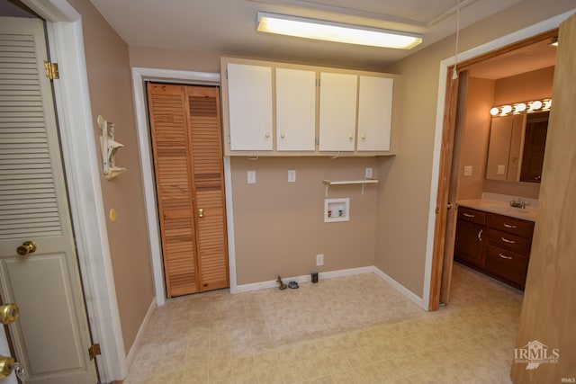 laundry area featuring gas dryer hookup, cabinets, sink, and hookup for a washing machine