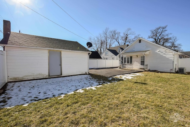 rear view of property featuring cooling unit, a yard, and a patio area