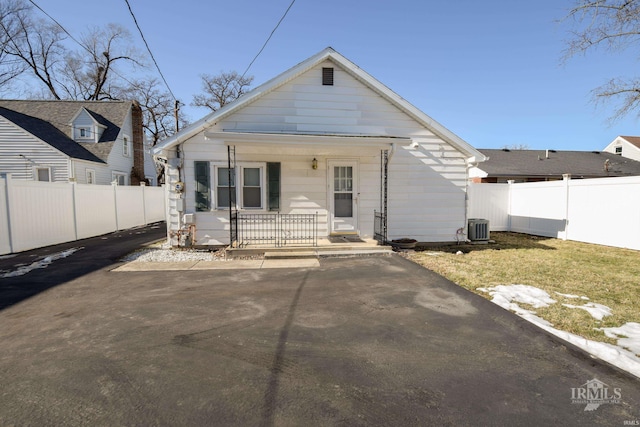 rear view of property featuring central AC and covered porch