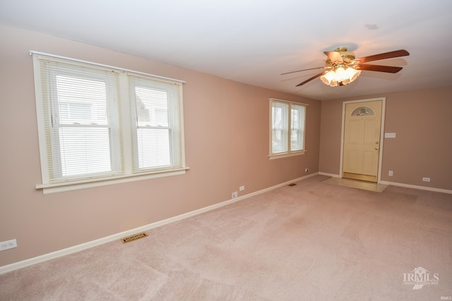 unfurnished room featuring ceiling fan and light carpet