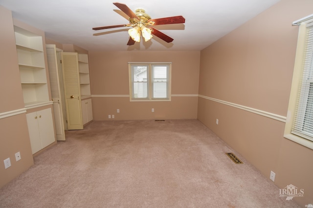 unfurnished bedroom featuring light carpet and ceiling fan