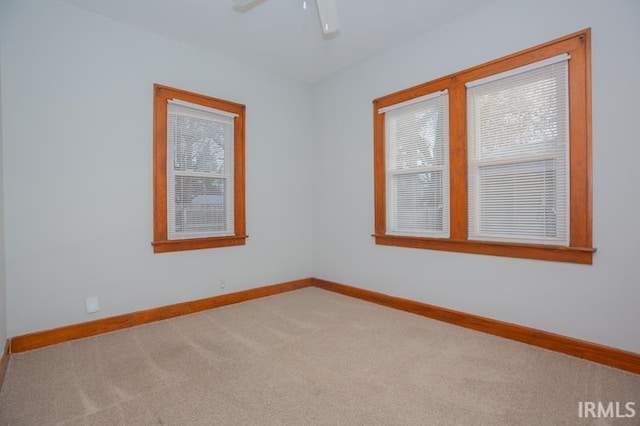 unfurnished room with carpet floors and ceiling fan