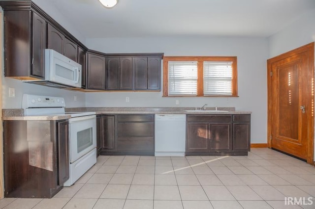 kitchen featuring sink, white appliances, dark brown cabinets, and light tile patterned floors