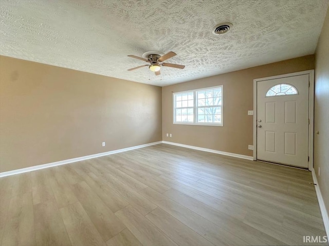 entryway featuring a textured ceiling, light hardwood / wood-style floors, and ceiling fan