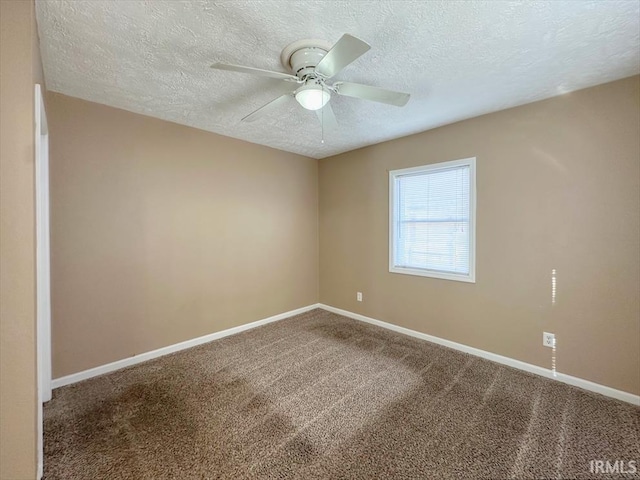 empty room featuring carpet, a textured ceiling, and ceiling fan