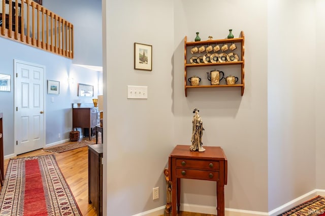 hall with hardwood / wood-style floors