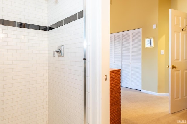 bathroom with tiled shower