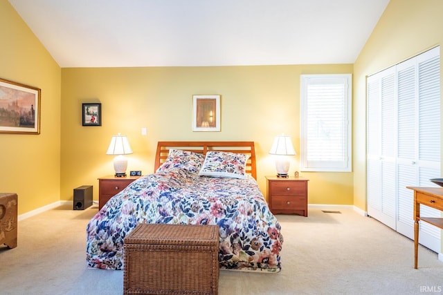 bedroom with vaulted ceiling and light colored carpet