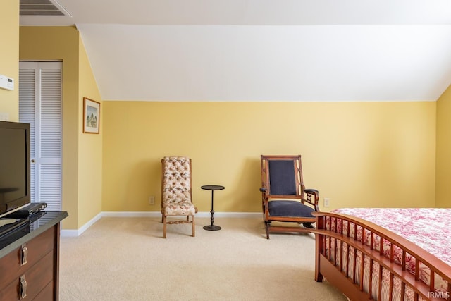 bedroom with light carpet and lofted ceiling