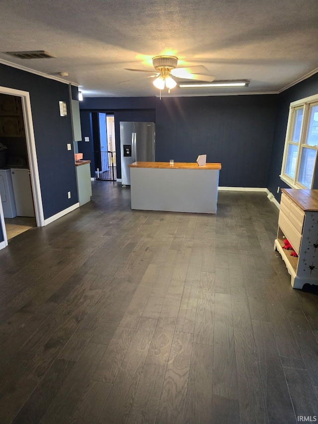 interior space featuring crown molding, ceiling fan, a textured ceiling, and dark hardwood / wood-style flooring