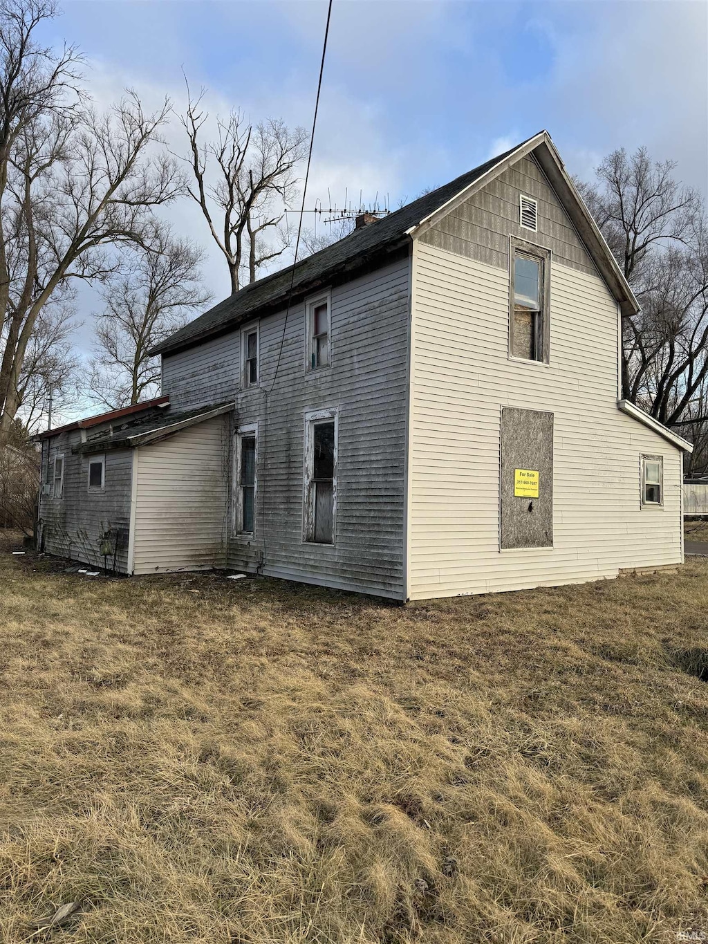 rear view of house featuring a lawn