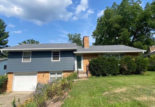 view of front of property with a garage and a front yard