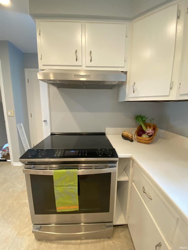 kitchen with white cabinetry and electric range