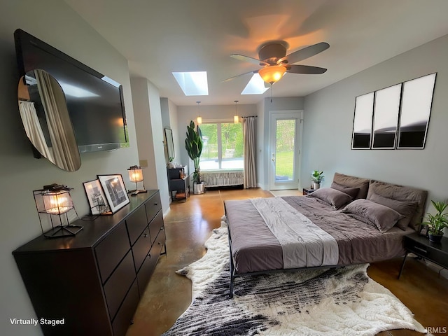 bedroom with ceiling fan, radiator heating unit, and a skylight