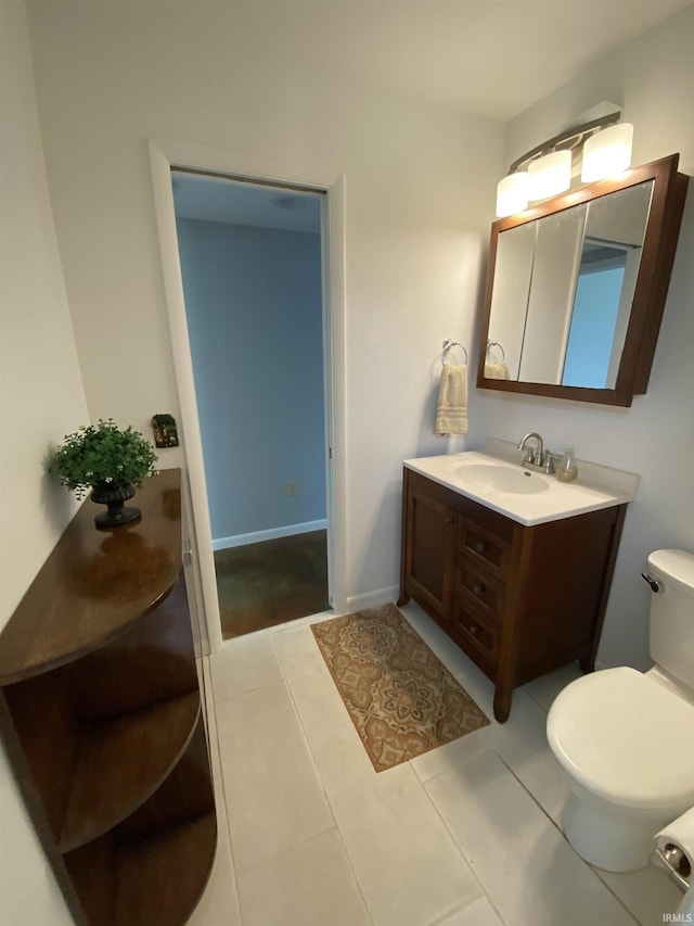 bathroom featuring tile patterned flooring, vanity, and toilet