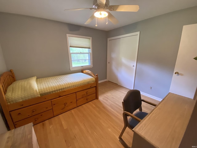 bedroom with a closet, ceiling fan, and light wood-type flooring