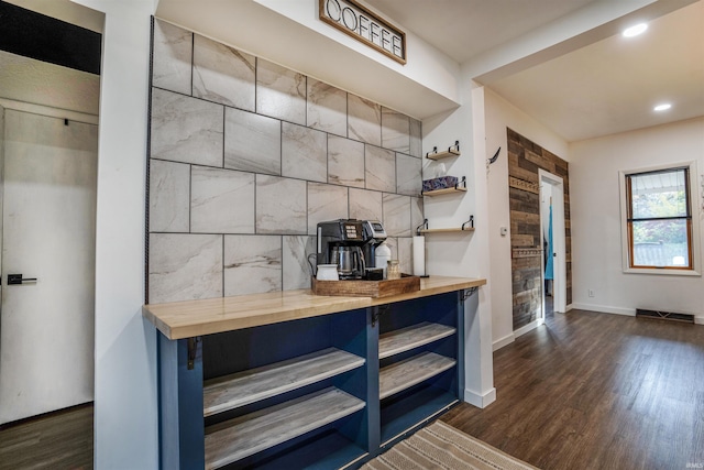 bar featuring dark hardwood / wood-style flooring and butcher block counters