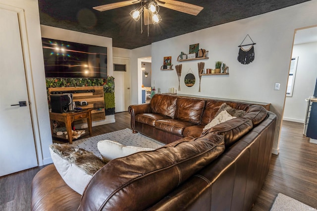 living room featuring dark hardwood / wood-style floors and ceiling fan