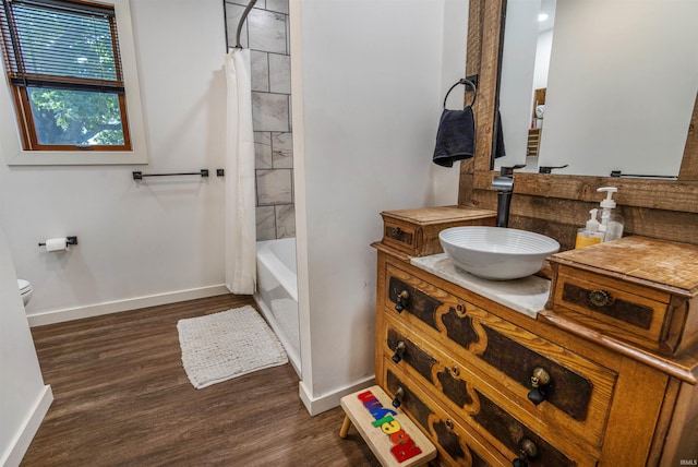 full bathroom featuring shower / bath combination with curtain, wood-type flooring, vanity, and toilet