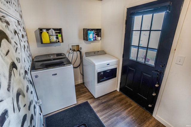 clothes washing area with dark wood-type flooring and independent washer and dryer