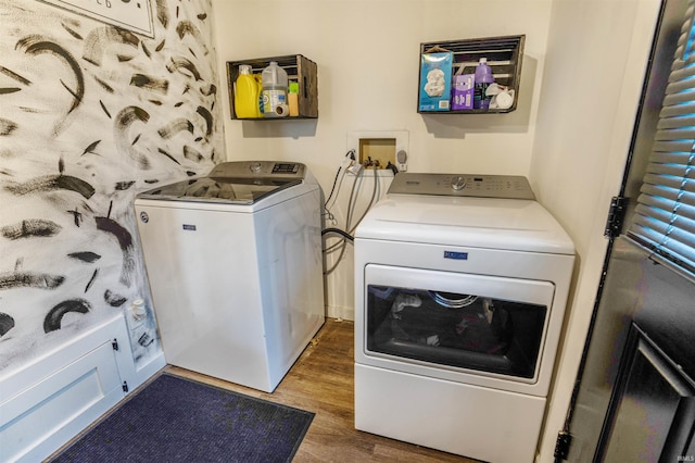 clothes washing area featuring dark hardwood / wood-style floors and washing machine and dryer