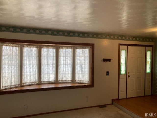 view of carpeted entrance foyer