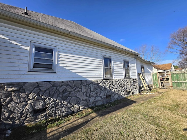 view of side of home with a yard