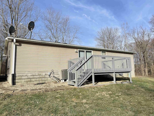 rear view of house with a yard, a deck, and central air condition unit