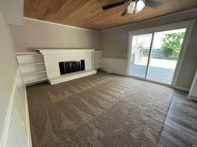 unfurnished living room with ceiling fan, dark hardwood / wood-style floors, a fireplace, and wood ceiling