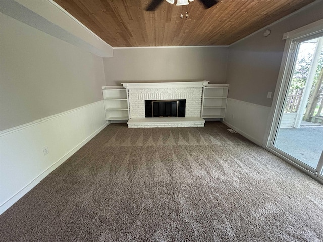 unfurnished living room featuring a fireplace, wooden ceiling, ceiling fan, and carpet