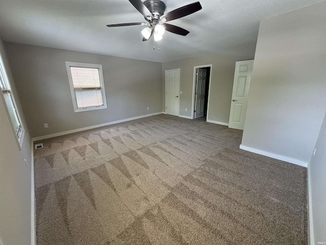 unfurnished room featuring ceiling fan and carpet flooring